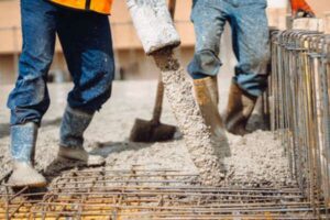 close-up-details-of-house-building-details-worker-pouring-concrete-into-house-beams+1