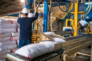 worker-loading-rows-stacks-white-sack+1