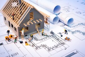 building-house-on-blueprints-with-worker-construction-project