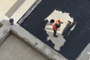 the-worker-in-overalls-applies-an-insulation-coating+1