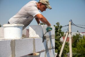 worker-builds-the-walls-of-a-house-from-aerated-concrete-bricks+1